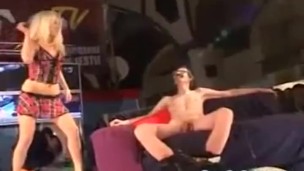Porn on stage teasing a horny guy while stripping wild