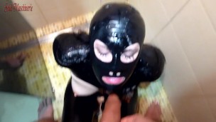 slut in shiny black latex drinking Master's piss