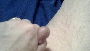 Cock playing with a red dildo