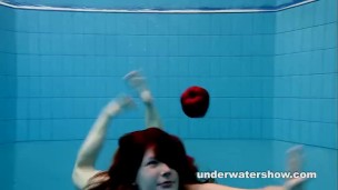 Redhead Mia stripping underwater
