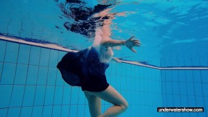 Teen girl Avenna is swimming in the pool