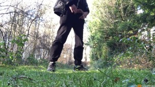 boy is urinating in the woods