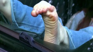 Bare feet against windshield