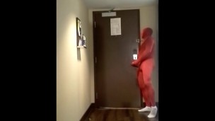 red morphsuit jerking off at hotel room door