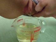 pee in measuring cup | close up