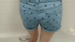 girl wets her denim shorts