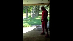 red zentai jerking off at garage door