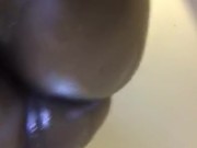 Ebony babe massaging her fat ass with oil