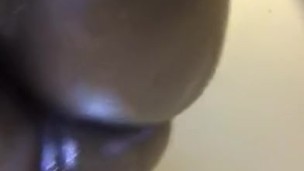 Ebony babe massaging her fat ass with oil
