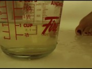 peeing into a measuring cup