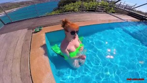 Horny redhead MILF fucks herself in the pool, until cock arrives!