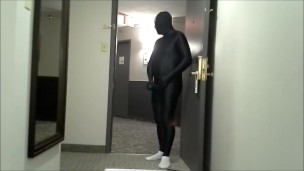 skeleton faced white socked black morphman in front of hotel room