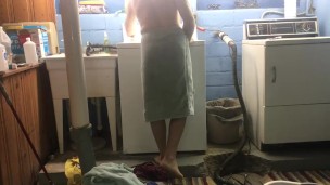 Naked man doing laundry