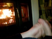 A wank by the fireplace.