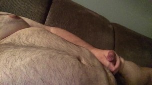 Front couch wank to some straight porn