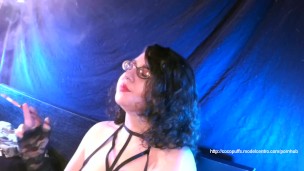 Coco smoking elegantly with holder and lace gloves