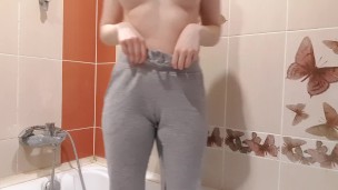Girl peeng in gray yoga pants