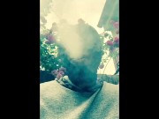 Masked ebony bbw smoking outside in garden and rubbing pussy