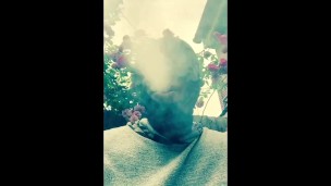 Masked ebony bbw smoking outside in garden and rubbing pussy