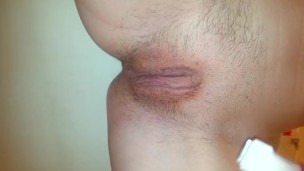 Teen shaves her hairy pussy with an electric razor in the shower.