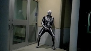 nighttime skeleton jerking off in front of outside doors