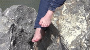 the feet of a mature lady on stones