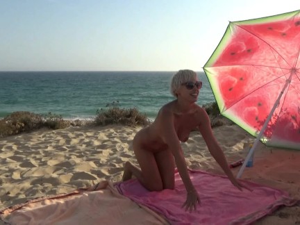 Gangbang, blowjob and fucking on a nudist beach. Blonde and 5 guys.