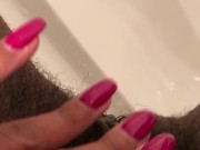 Close up pee in black stripper heels.