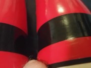 Shiny red latex rubber stockings closeup