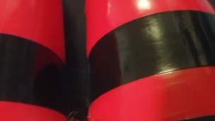 Shiny red latex rubber stockings closeup