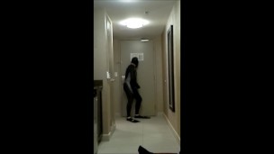 wearing wetsuit and fins shoot a quick load at open hotel door