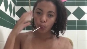 Teen sucks lollipop while playing with titts in shower