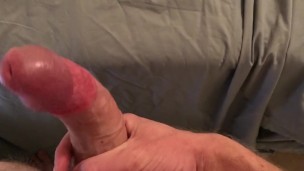 Guy jerks himself off, standing up then cums on the sheets