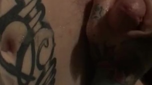 Boy oils body and plays with big piercied tattooed cock