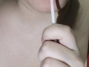 Horny chubby girl licking lollipop