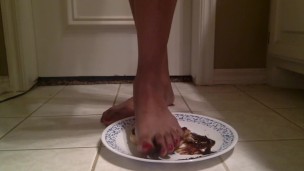 Tgirl crushes a chocolate donut under her foot