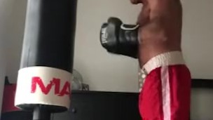 working the bag in red boxing trunks