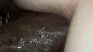 Strap-on and dick penetrate pussy at the same time.