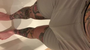 Tattooed guy wetting boxers