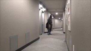 jerking off in hotel hall in wetsuit and trench coat