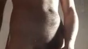 Standing, undressing and pulling cock Fire Boy