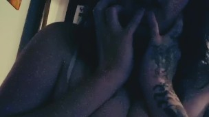 Ellie plays with her tits while watching cartoons