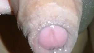 Slow-motion HD closeup of leaking flaccid asian penis