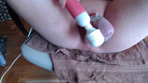 Sissy teasing his caged cock with hitachi wand