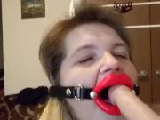 Trying to talk while giving a blowjob to Dildo, wearing open mouth gag