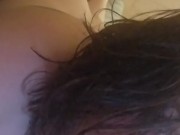 Laying in bed naked.
