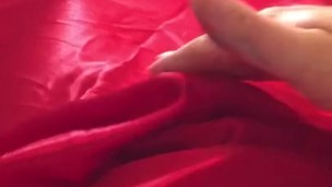 Man In Latex Catsuit Rubbing Cock With Satin Sheets