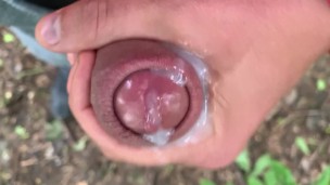Close up look on glans with precum and close up cum leaking - uncut cock