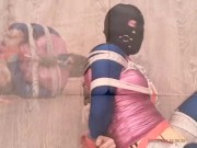 Self bondage in shiny spandex and swimsuit