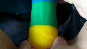 Cumming on a rainbow dildo in bed